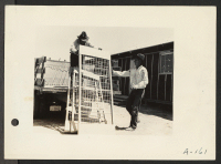 [recto] Poston, Ariz.(Site #1)--Apache Indians assist in the unloading of beds for evacuees of Japanese ancestry at this War Relocation Authority center which is located on the Colorado River Indian Reservation. ;  Photographer: Clark, Fred ;  Poston, Arizona