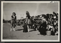 [recto] The visitors from Fillmore, Utah, brought a good cheering section with them when their high school team met Topaz High School at Topaz Relocation Center, November 11, 1943. Fillmore cheer leaders are shown here. ;  Topaz, Utah.