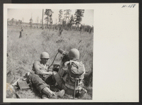 [recto] A machine gun crew hits the target during practice on the extensive firing range adjoining Camp Shelby. The 442nd combat ...