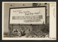 [recto] San Francisco, Calif. (Sutter and Octavia St.)--Billboard advertisement at edge of Japanese quarter, photographed on morning when 600 persons of Japanese ancestry from this section were evacuated to an assembly center. ;  Photographer: Lange, Dorothea