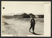 [recto] Military sentry keeping civilians away from mess hall at Poston 1. ;  Photographer: Clark, Fred ;  Poston, Arizona.