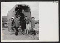 [recto] INCOMING--Arrivals boarding truck for transportation to barracks. ;  Photographer: Aoyama, Bud ;  Heart Mountain, Wyoming.