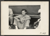 [recto] Sacramento, Calif.--Bill Fujii, evacuee of Japanese ancestry, who has completed three years in Commerce at the University of California. He is seen with other young students now spending the duration in War Relocation Authority Center. ;  Photographer: