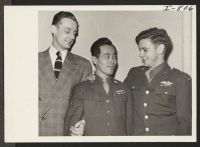 [recto] Emmet Duffy, Assistant State's Attorney, Pfc. Noboru Hokame, Hawaiian-born Japanese-American, and Pfc. Charles P. Carroll visited the WRA offices in ...