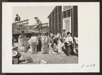 [recto] The arrival of kindling wood from the contractor's stock pile means new shiny blocks for the Grade School children. ;  Photographer: Parker, Tom ;  McGehee, Arkansas.