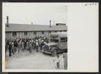 [recto] A crowd of Topaz residents is here shown at one of the mess hall assembly centers where they gathered to bid goodbye to friends and relatives leaving for the Tule Lake Center. ;  Photographer: Mace, Charles E. ;  Topaz, Utah.