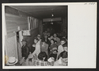 [recto] Tule Lake induction center. New arrivals from Topaz are shown waiting to have their identification pictures taken and finger prints made. ;  Photographer: Mace, Charles E. ; , .