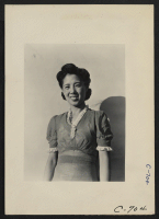 [recto] Manzanar, Calif.--Mrs. Togo Tanaka, American-born mother of Japanese ancestry, now at this War Relocation Authority center. Her husband is active in governmental affairs within the center. ;  Photographer: Lange, Dorothea ;  Manzanar, California.