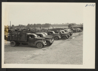 [recto] Closing of the Jerome Center, Denson, Arkansas. View in the Jerome motor pool showing trucks and other vehicles assembled for shipment to other centers. ;  Photographer: Mace, Charles E. ;  Denson, Arkansas.