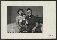 [recto] A typical Nisei family, Bill, Alice and Young Mike Hosokawa. Bill is editor of the Heart Mountain Sentinel, Heart Mountain Relocation Center Newspaper. ;  Photographer: Parker, Tom ;  Heart Mountain, Wyoming.