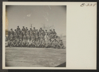 [recto] A group picture of the Manzanar fire men and fire marshals posed with their fire truck. ;  Photographer: Stewart, Francis ;  Manzanar, California.
