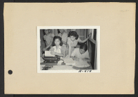 [recto] Poston, Ariz.--(Site #1)--Alice Maeda signs up the Shiomichi family at the intake center for the War Relocation Authority Work Corps. (L to R) Toke Shiomichi, Alice Maeda, Joe and Edna Shiomichi, Mrs. Shiomichi. ;  Photographer: Clark, Fred ;  Poston,