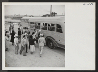 [recto] Final goodbyes are called through the bus windows as Topaz residents leave the center to entrain for Tule Lake. ;  Photographer: Mace, Charles E. ;  Topaz, Utah.