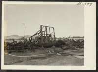 [recto] Shown here are the remains of the six barracks after the fire on Christmas night, 1943, which swept block 202, Poston No. II. ;  Poston, Arizona.