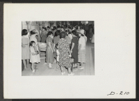 [recto] Crowds of evacuees witnessed the local handicraft and art display held at the recreation halls at this center on Labor Day. ;  Photographer: Stewart, Francis ;  Newell, California.