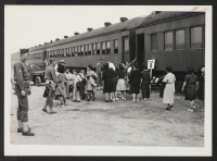 [recto] INCOMING--Arrivals from Tule Lake leaving train. ;  Photographer: Aoyama, Bud ;  Heart Mountain, Wyoming.