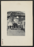 [recto] Manzanar, Calif.--Left to right, Mrs. T. Kakehashi; Mitsoshi Shijo, 5 months old, and Mrs. M. Shijo, seated on a rustic ...