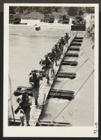 [recto] Building a Pontoon Bridge. A company of infantry arrives by truck and moves over the hastily constructed bridge in double ...