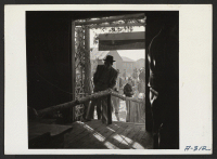 [recto] New Year's Fair. Crowds entering the agricultural exhibit. ;  Photographer: Stewart, Francis ;  Poston, Arizona.