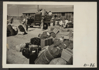 [recto] Eden, Idaho--Baggage, belonging to evacuees who have just arrived from the assembly center at Puyallup, Washington, is sorted and trucked to barrack apartments. ;  Photographer: Stewart, Francis ;  Hunt, Idaho.