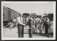 [recto] Project Director, Charles F. Ernst, bidding Shigeru Yamamoto, Chairman of the Resident Segregation Committee at Topaz, goodbye as the last train for Tule Lake pulls out. ;  Topaz, Utah.