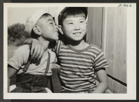 [recto] Parker, Arizona--These two little evacuees of Japanese ancestry are getting acquainted at this War Relocation Authority center. ;  Photographer: Stewart, Francis ;  Poston, Arizona.