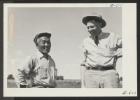 [recto] Jitsumi Abe, unit supervisor, and John N. Spencer, Chief of the Granada Farm Division. ;  Photographer: McClelland, Joe ;  Amache, Colorado.