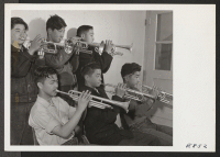 [recto] A part of the brass section of the High School Band, at the Rohwer Center. The students learning to play instruments for the band are former Californians, who, with their parents, were evacuated from strategic west coast areas. ;  Photographer: Parker,