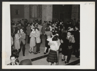 [recto] Happy Nisei and Caucasian couples throng the dance floor of the YMCA at the All-American Fun Night program in Chicago ...