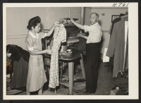 [recto] Mr. and Mrs. Shotsu Gishifu from Topaz, at work in their cleaning and tailoring establishment at 1704 Lagune Street in ...