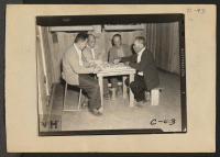 [recto] Manzanar, Calif.--Playing Japanese checkers at this War Relocation Authority center for evacuees of Japanese descent where they are spending the duration. ;  Photographer: Albers, Clem ;  Manzanar, California.