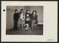 [recto] A family of newly arrived evacuees from Hawaii inspect their new barracks home at this War Relocation Authority Center for evacuees of Japanese ancestry. ;  Photographer: Stewart, Francis ;  Topaz, Utah.