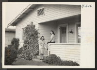 [recto] Sumi Iwata and her sister Ethel relax on the porch of their attractive home at Mountain View, California, near San ...