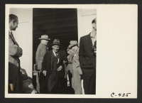 [recto] San Francisco, Calif. (2020 Van Ness Ave.)--This evacuee of Japanese ancestry has been checked by officials and is about ready to board the evacuation bus for an Assembly Center. ;  Photographer: Lange, Dorothea ;  San Francisco, California.