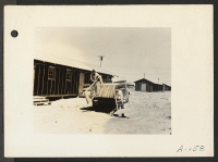 [recto] Poston, Ariz.--Apache Indians are assisting in the unloading of beds for evacuees of Japanese ancestry at this War Relocation Authority center which is located on the Colorado River Indian Reservation. ;  Photographer: Clark, Fred ;  Poston, Arizona.
