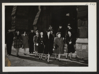 [recto] After Sunday church services with their Caucasian friends, the Niseis leave for a stroll along Michigan Boulevard in Chicago. Chicago Nisei like to go to church and here is a group which just attended Sunday services at the Second Presbyterian Church.