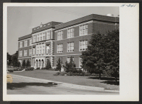 [recto] High School in Lawrence, Kansas. This building is typical of high school buildings throughout the middle west. ;  Photographer: Mace, Charles E. ;  Lawrence, Kansas.
