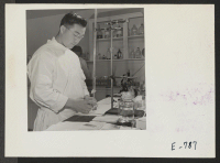 [recto] Tom Arasae, former California Bio-Chemistry student, performs a gastro analysis in the center hospital laboratory. ;  Photographer: Parker, Tom ;  Denson, Arkansas.