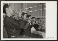 [recto] A trombone section of the High School Band in a practice session at the school band room. Most of the ...