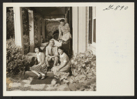 [recto] Mr. and Mrs. Teruharu Suzuki and their daughter, Peggy, with Mr. and Mrs. Jose Machado, on the porch of the ...