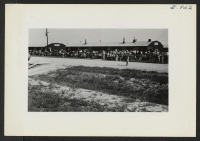 [recto] Typical crowd in front of Warehouse 12 watching the departure of the segregation train. ;  Photographer: Lynn, Charles R. ;  Dermott, Arkansas.