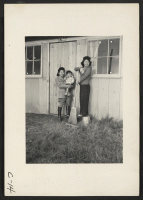 [recto] Arcadia, Calif.--At the entrance of their barrack apartment at the Santa Anita assembly center. As soon as housing facilities are made available, evacuees of Japanese ancestry will be transferred to War Relocation Authority centers to spend the duration.