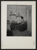 [recto] View of the home of Mrs. Eizo Nishi. This view shows attractive scene in which this evacuee family has decorated their barrack apartment. ;  Photographer: Stewart, Francis ;  Hunt, Idaho.