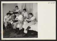 [recto] Relaxing in their apartment after a hard day's work in a dehydration laboratory near Lawrence, Kansas, these six youths, from ...