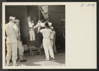 [recto] Closing of the Jerome Center, Denson, Arkansas. A hospital case is loaded by stretcher and will be cared for by Army nurses during the trip to the Gila River Center. ;  Photographer: Iwasaki, Hikaru ;  Denson, Arkansas.
