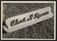 [recto] Woodcarving--Name Plate--Granada Project, Amache, Colorado, October 8, 1945. ;  Photographer: Iwasaki, Hikaru ;  Amache, Colorado.