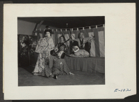 [recto] A group of actors in a scene from a play depicting a legendary incident of old Japan, as presented at an entertainment program at this relocation center. ;  Photographer: Parker, Tom ;  Heart Mountain, Wyoming.