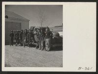 [recto] Evacuee firemen are shown posed beside their fire truck. Excellent work by this trained crew has minimized fire and fire damage in this War Relocation Authority Center for evacuees of Japanese descent. ;  Photographer: Stewart, Francis ;  Topaz, Utah.