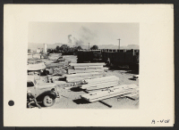 [recto] Poston, Arizona--Loading lumber for use in the construction of living quarters for evacuees of Japanese ancestry at the Colorado River War Relocation Authority Center. ;  Photographer: Clark, Fred ;  Poston, Arizona.