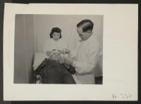 [recto] Hospital Series. Scene in out patients clinic, where Jimmie has an injured thumb repaired. (L to R) Dr. Robert H. Shiomi, Niyoko Shitamae, nurse, Jimmie Shimizu, patient. ;  Photographer: Stewart, Francis ;  Hunt, Idaho.